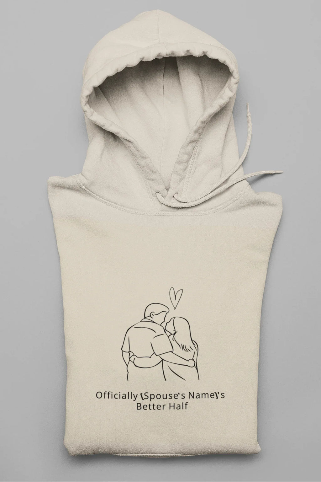 Cream hooded sweatshirt folded with front couple graphic and drawstring hood
