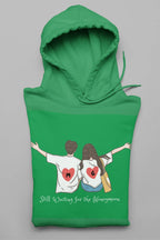 Green hoodie with hood and front pocket, featuring couple heart graphic and text.
