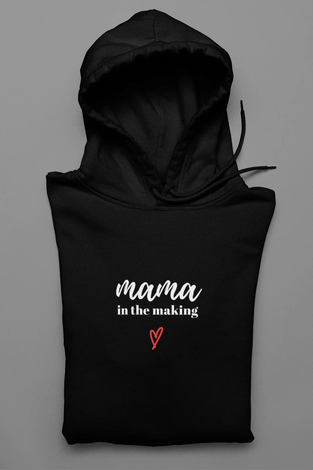 Black hooded sweatshirt with 'mama in the making' logo and red heart