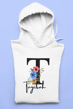 White kids hoodie with hood, large floral letter and script name graphic on chest