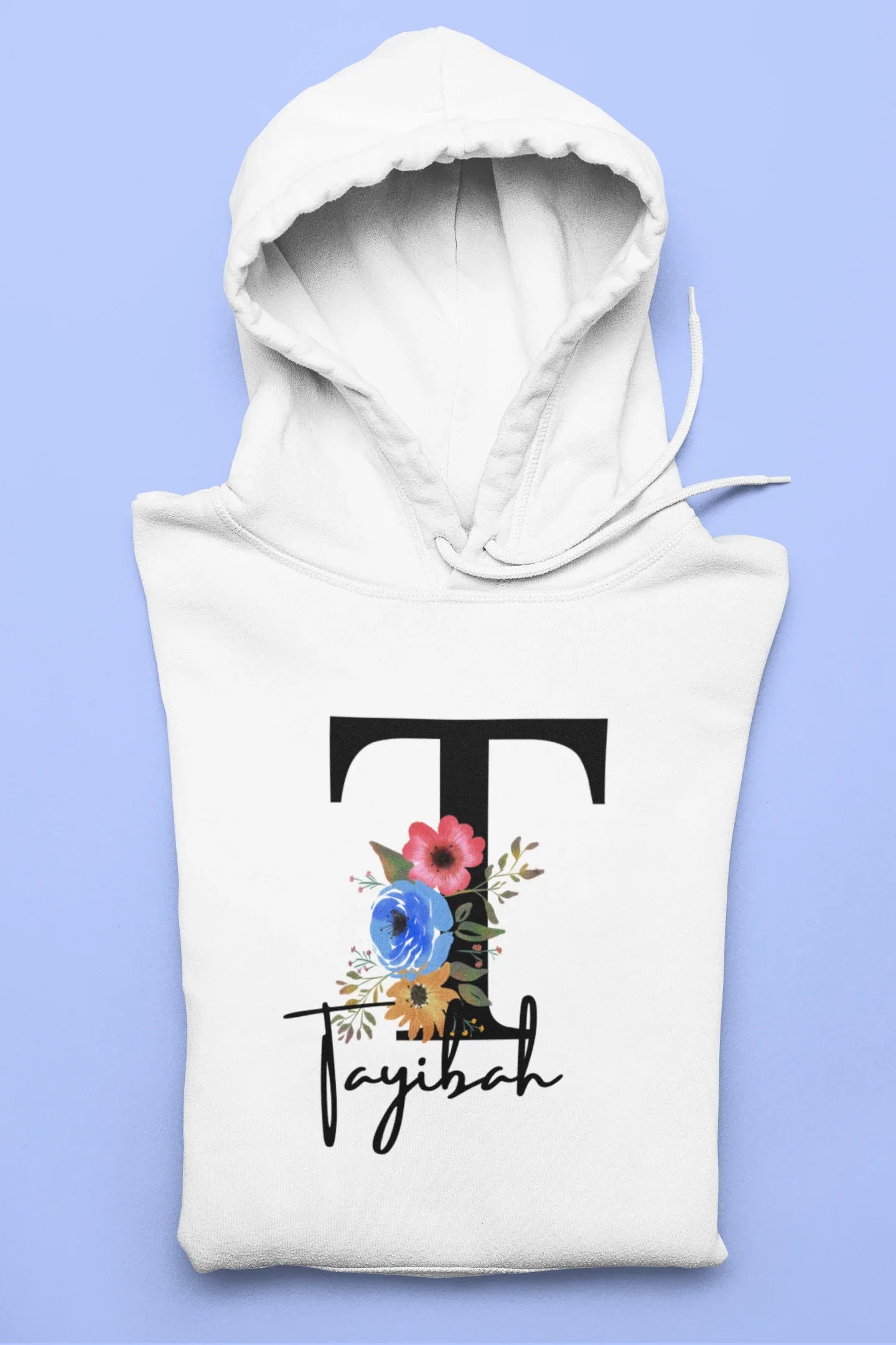 White kids hoodie with hood, large floral letter and script name graphic on chest