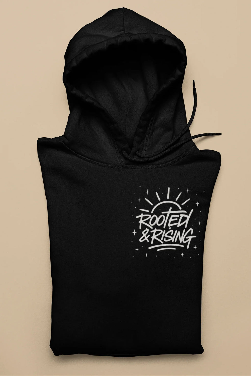 Black pullover hoodie with hood and 'Rooted & Rising' front graphic