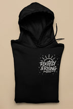 Black pullover hoodie with hood and 'Rooted & Rising' front graphic