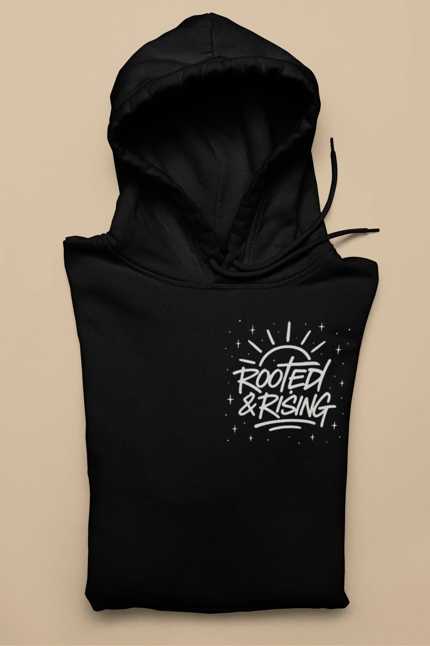 Black pullover hoodie with hood and 'Rooted & Rising' front graphic