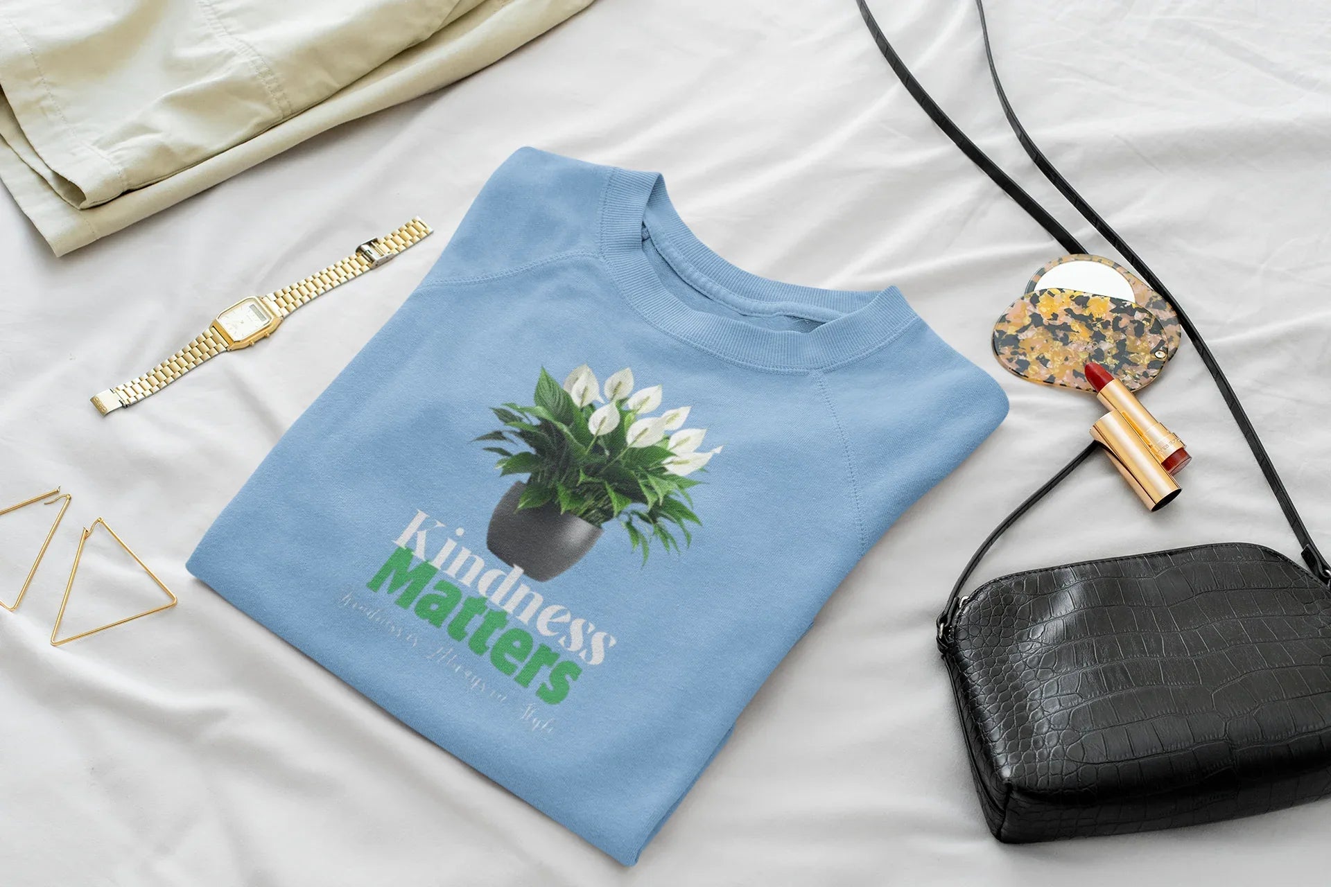 Light blue crewneck sweatshirt with tree graphic and 'Kindness Matters' print