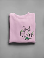 Light pink crewneck sweatshirt with floral “Just Bloom” graphic