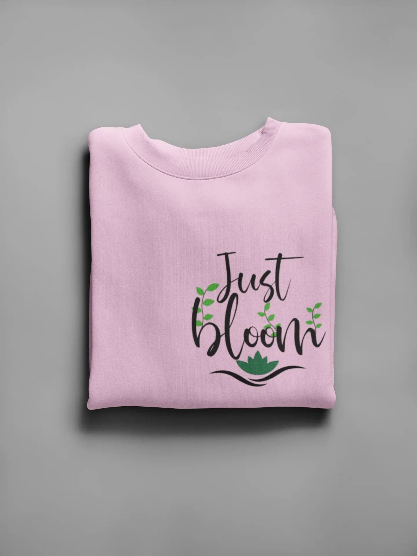 Light pink crewneck sweatshirt with floral “Just Bloom” graphic