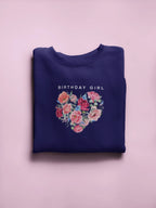 Navy crewneck sweatshirt with “Birthday Girl” text and floral heart graphic