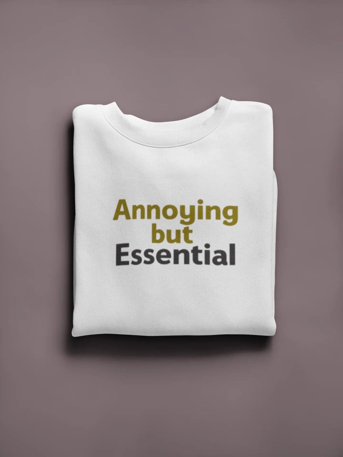 White unisex sweatshirt with 'Annoying but Essential' slogan text on front.