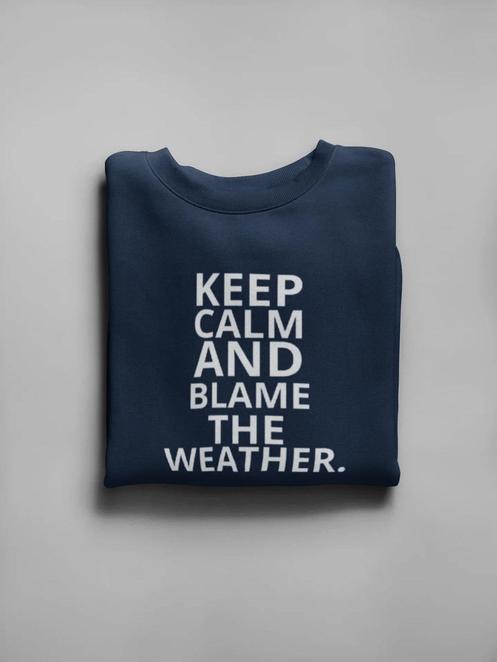 Navy crewneck sweatshirt with light text: "KEEP CALM AND BLAME THE WEATHER"
