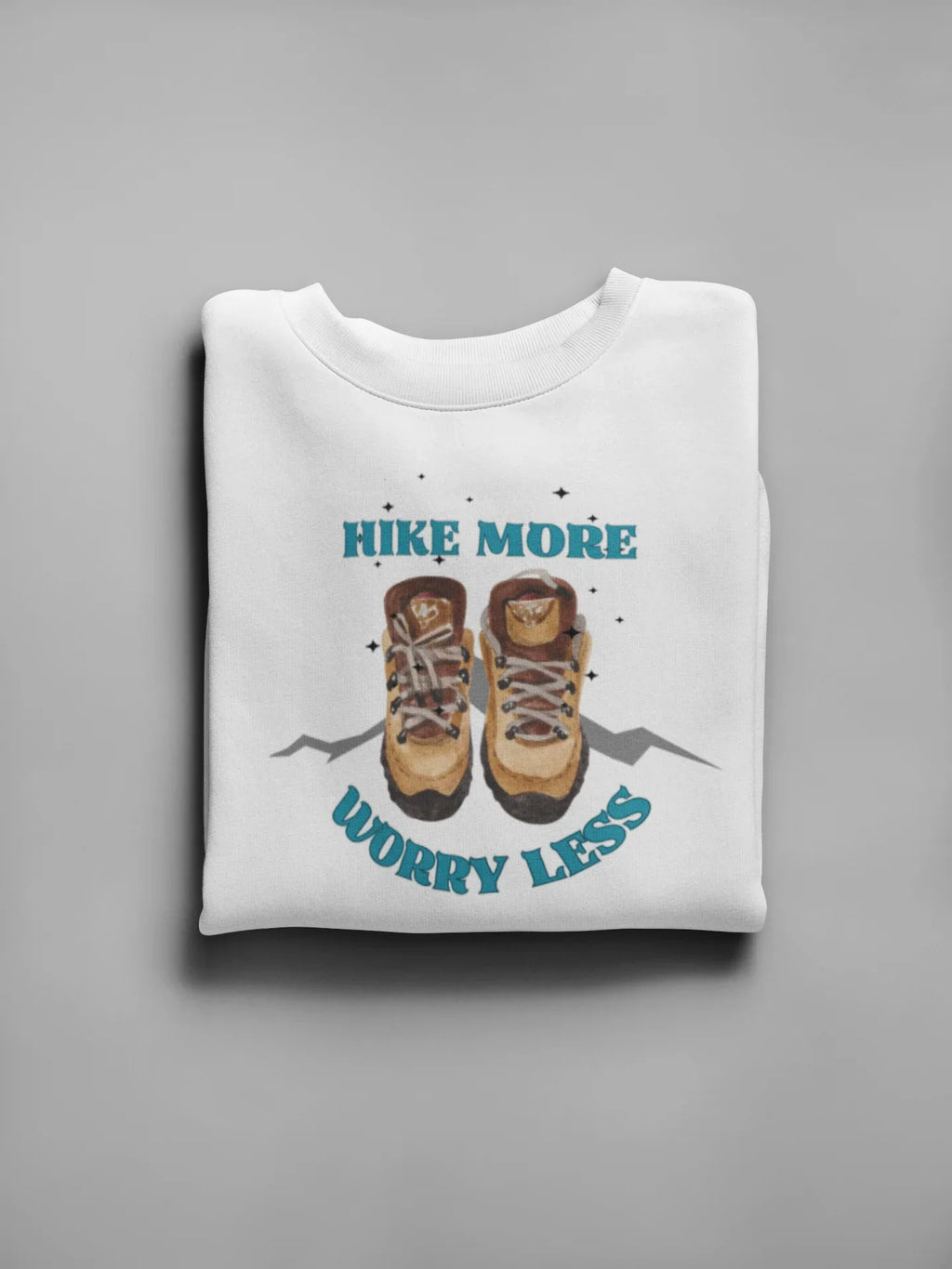 White crewneck sweatshirt with 'Hike More, Worry Less' hiking boots graphic on front