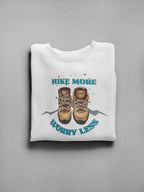 White crewneck sweatshirt with 'Hike More, Worry Less' hiking boots graphic on front