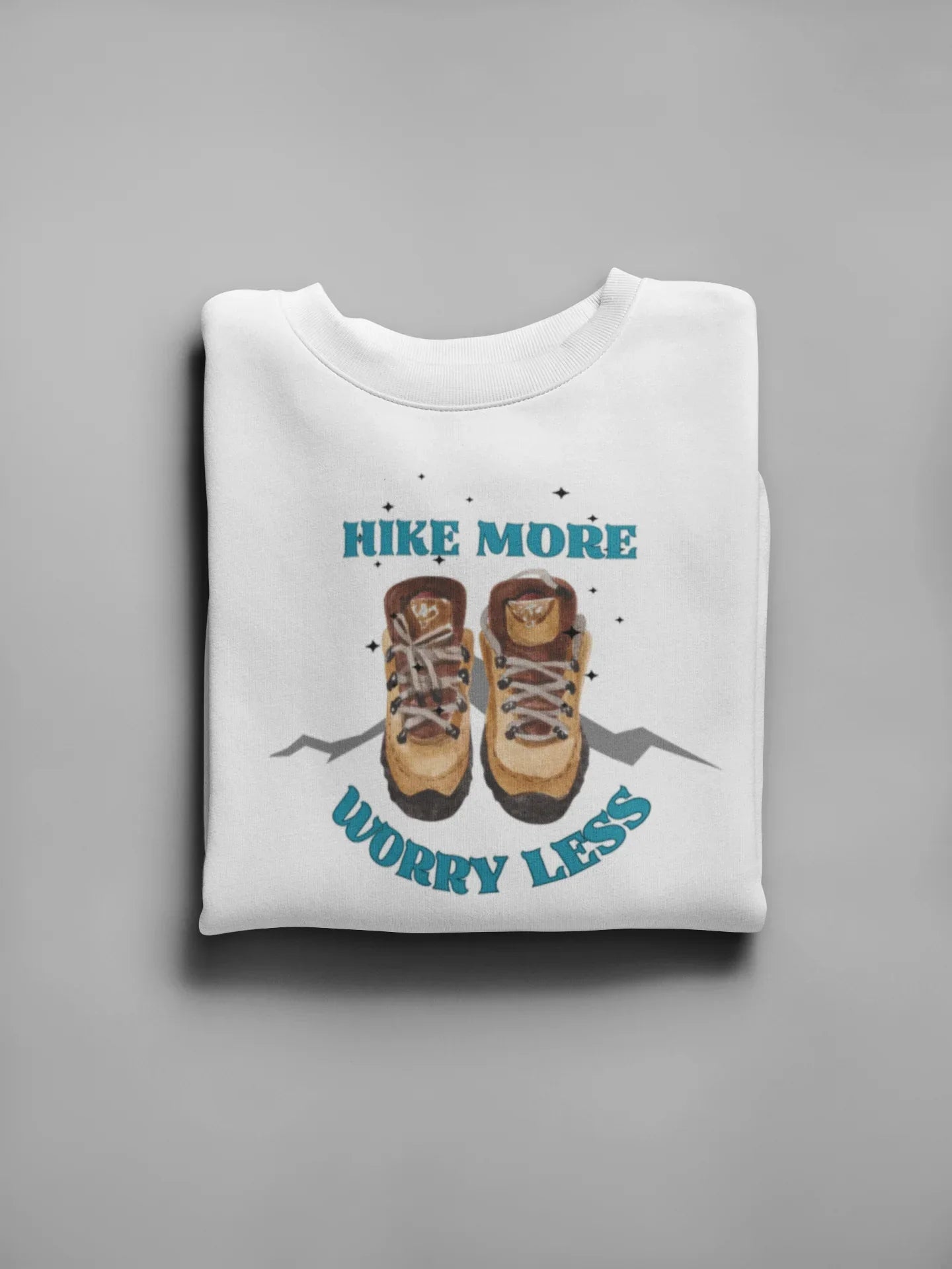 White crewneck sweatshirt with 'Hike More, Worry Less' hiking boots graphic on front