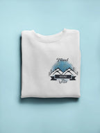 White crewneck sweatshirt with long sleeves and travel-themed chest logo graphic