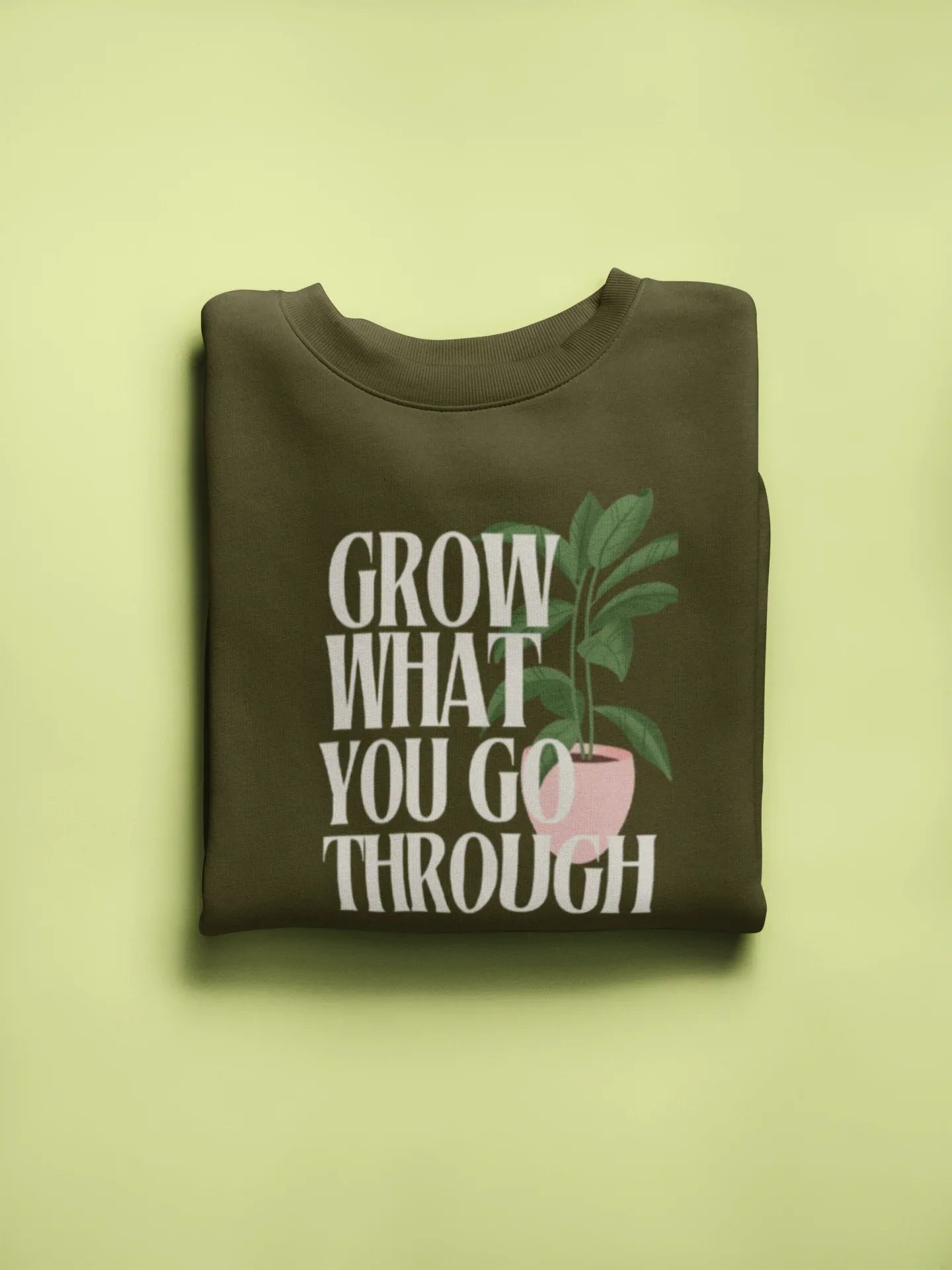 Dark olive sweatshirt with “Grow What You Go Through” text and leaf graphic