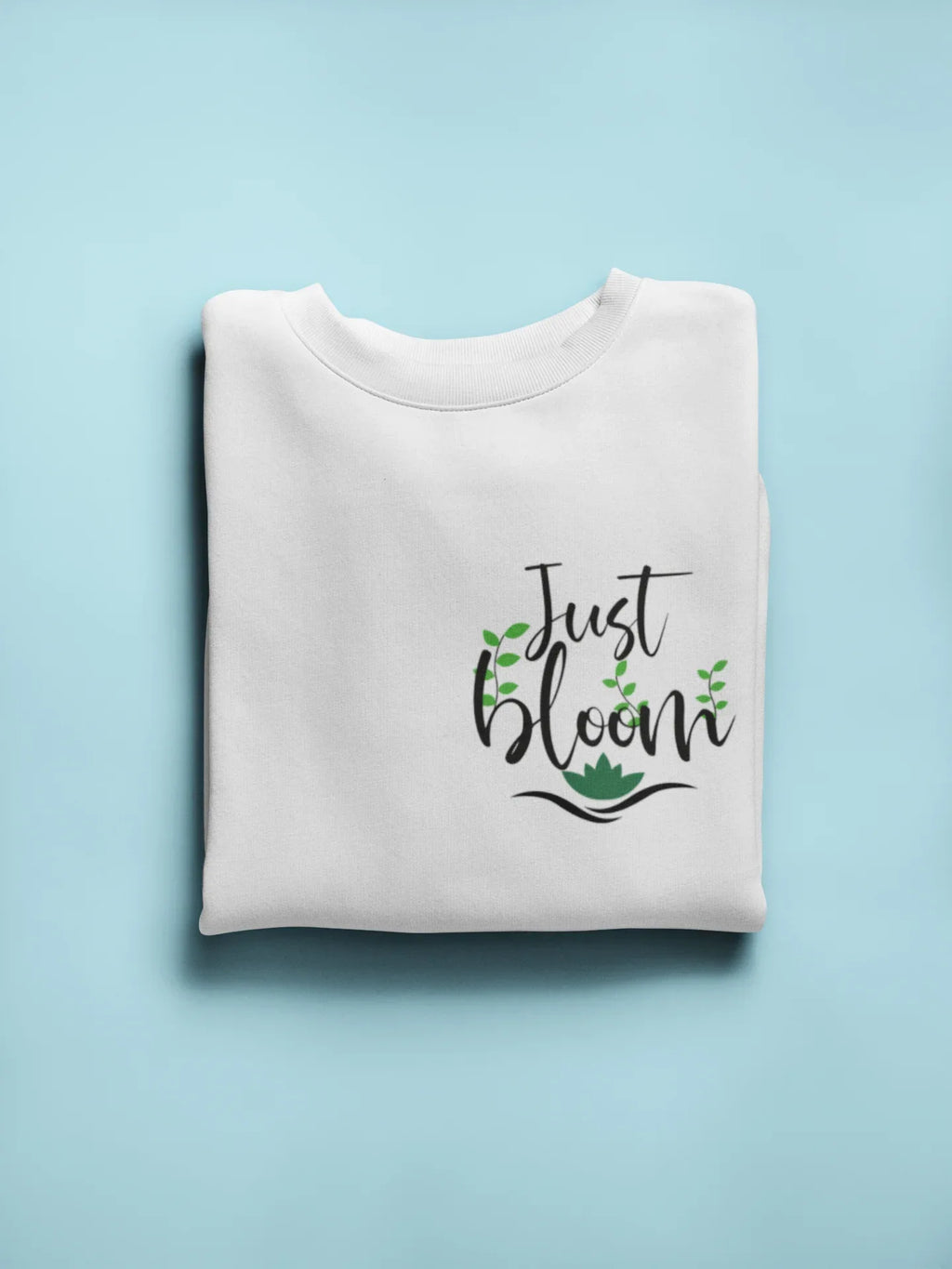 White crewneck sweatshirt with front “Just Bloom” floral graphic