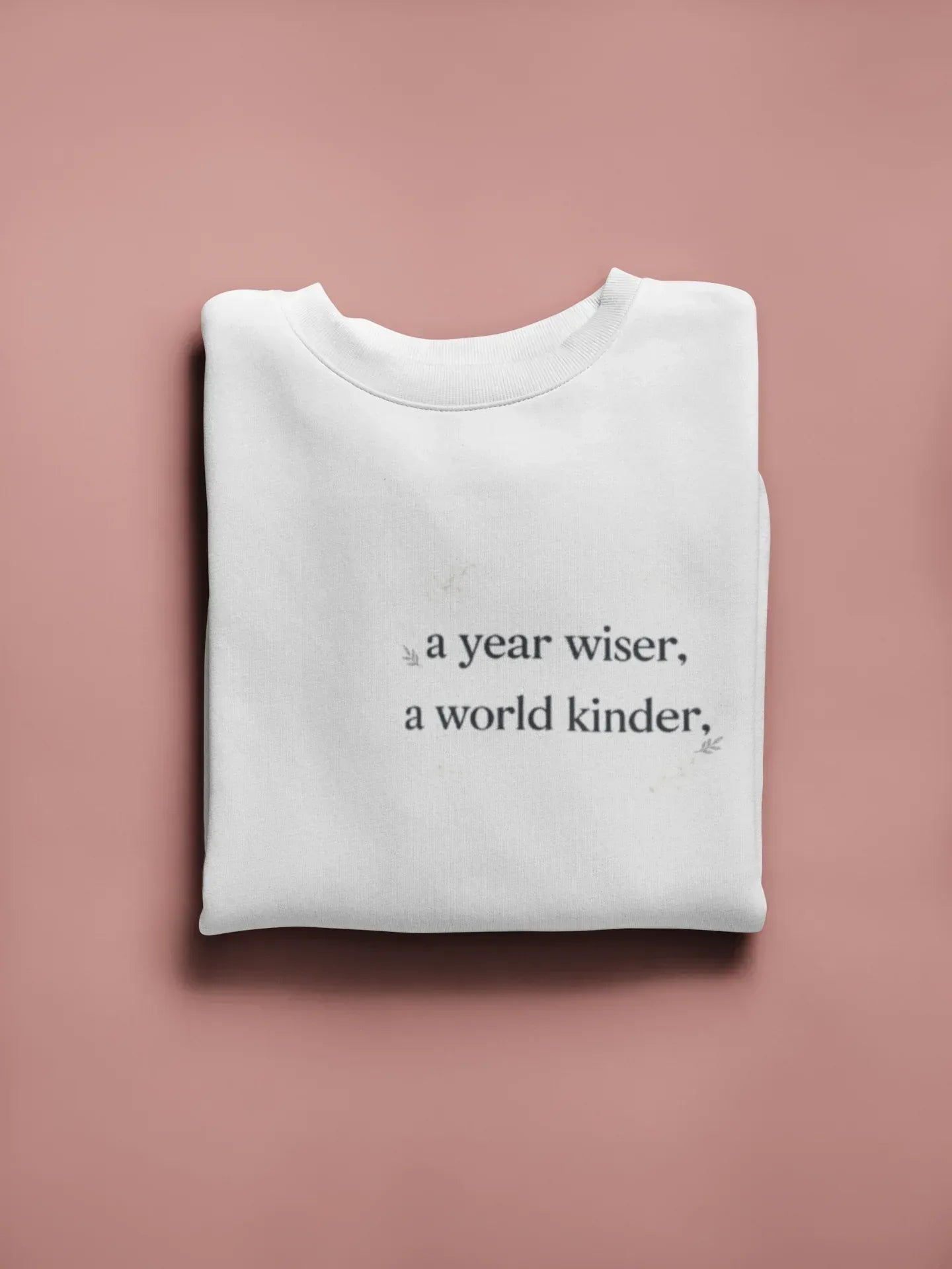 White crewneck sweatshirt with a year wiser, a world kinder print