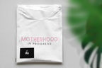 Maternity heavy cotton tee in white with pink “Motherhood in Progress” logo print
