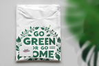 White unisex T-shirt folded with chest graphic print reading "GO GREEN OR GO HOME"