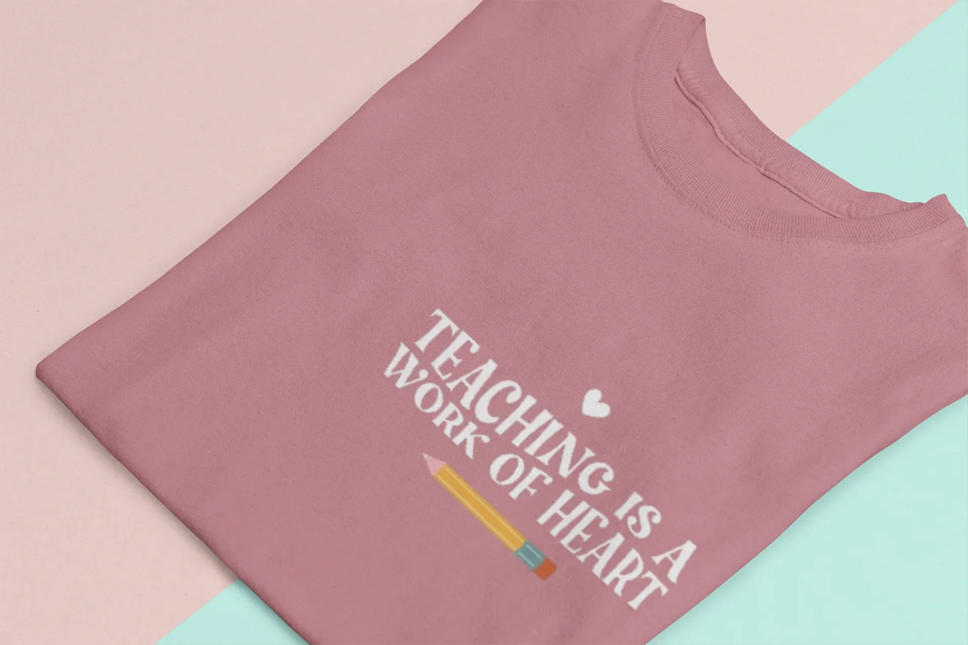 Mauve unisex T-shirt with crew neck and “Teaching is a Work of Heart” graphic print