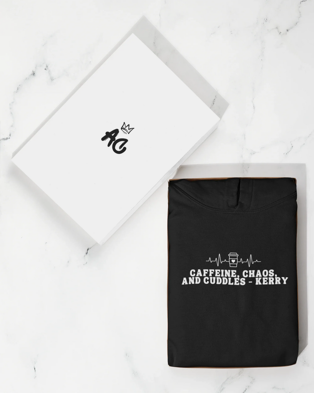 Black hoodie sweatshirt with 'Caffeine, Chaos, and Cuddles' front graphic