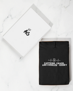 Black hoodie sweatshirt with 'Caffeine, Chaos, and Cuddles' front graphic
