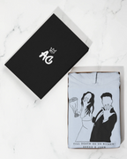 Personalised light blue hoodie folded in gift box, couple line-art graphic on front
