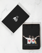 Black pullover hoodie with drawstring hood and couple graphic on front
