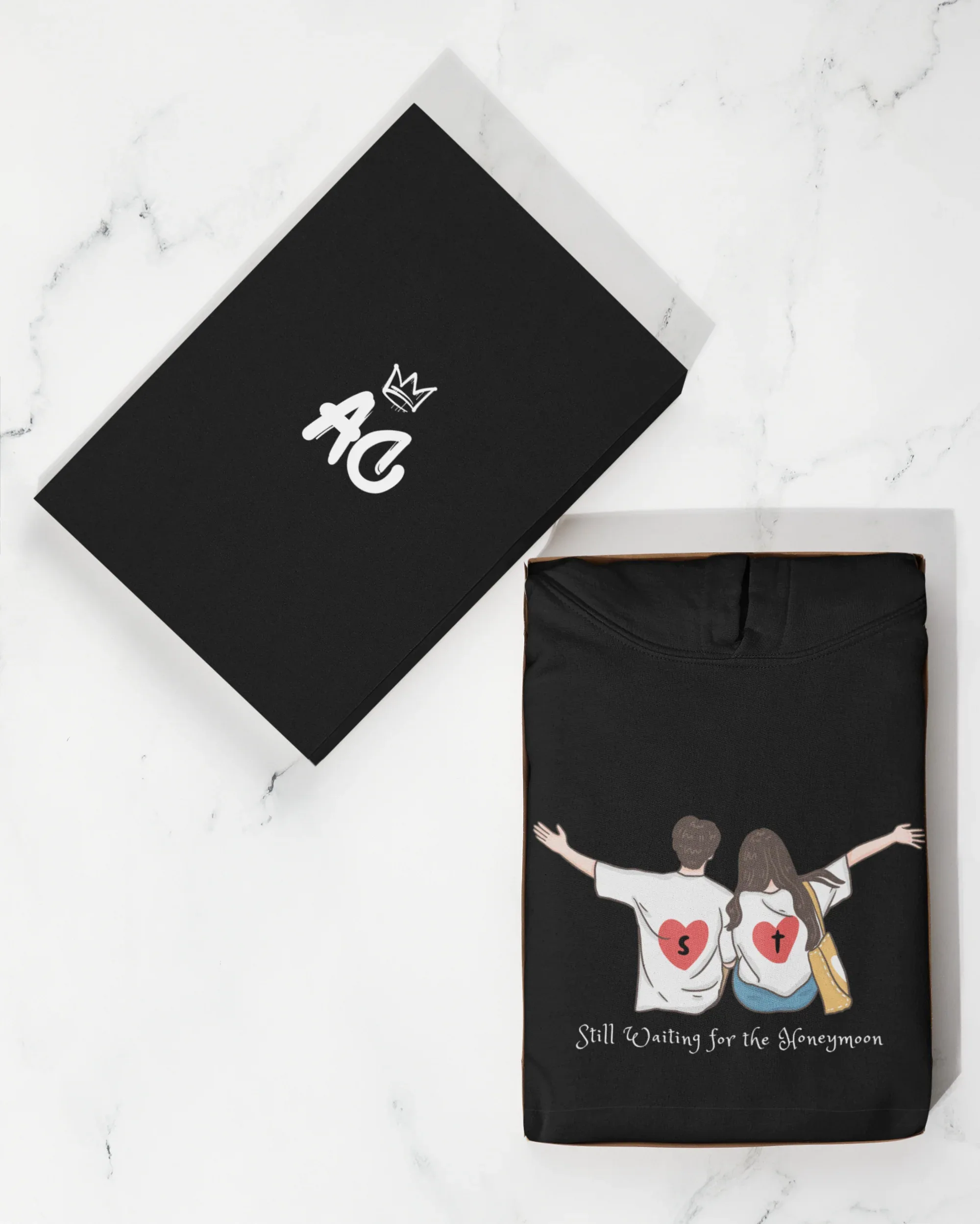 Black pullover hoodie with drawstring hood and couple graphic on front