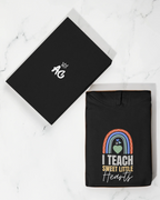 Black hoodie with front rainbow heart graphic; flat accessory card with small hand icon