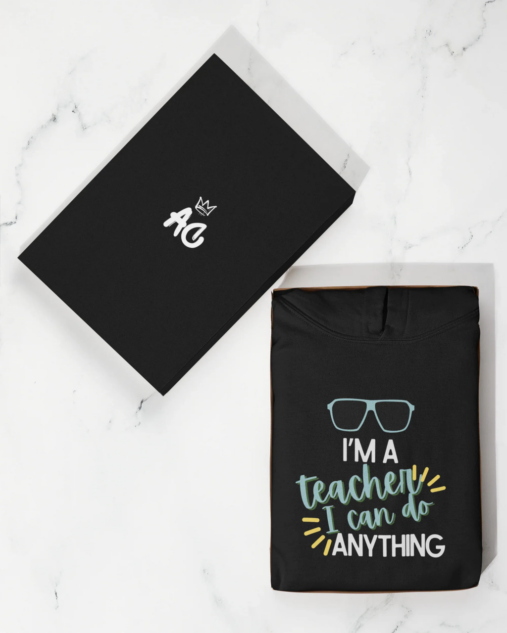 Black unisex hoodie with front teacher slogan print and hood
