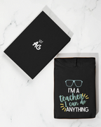 Black unisex hoodie with front teacher slogan print and hood