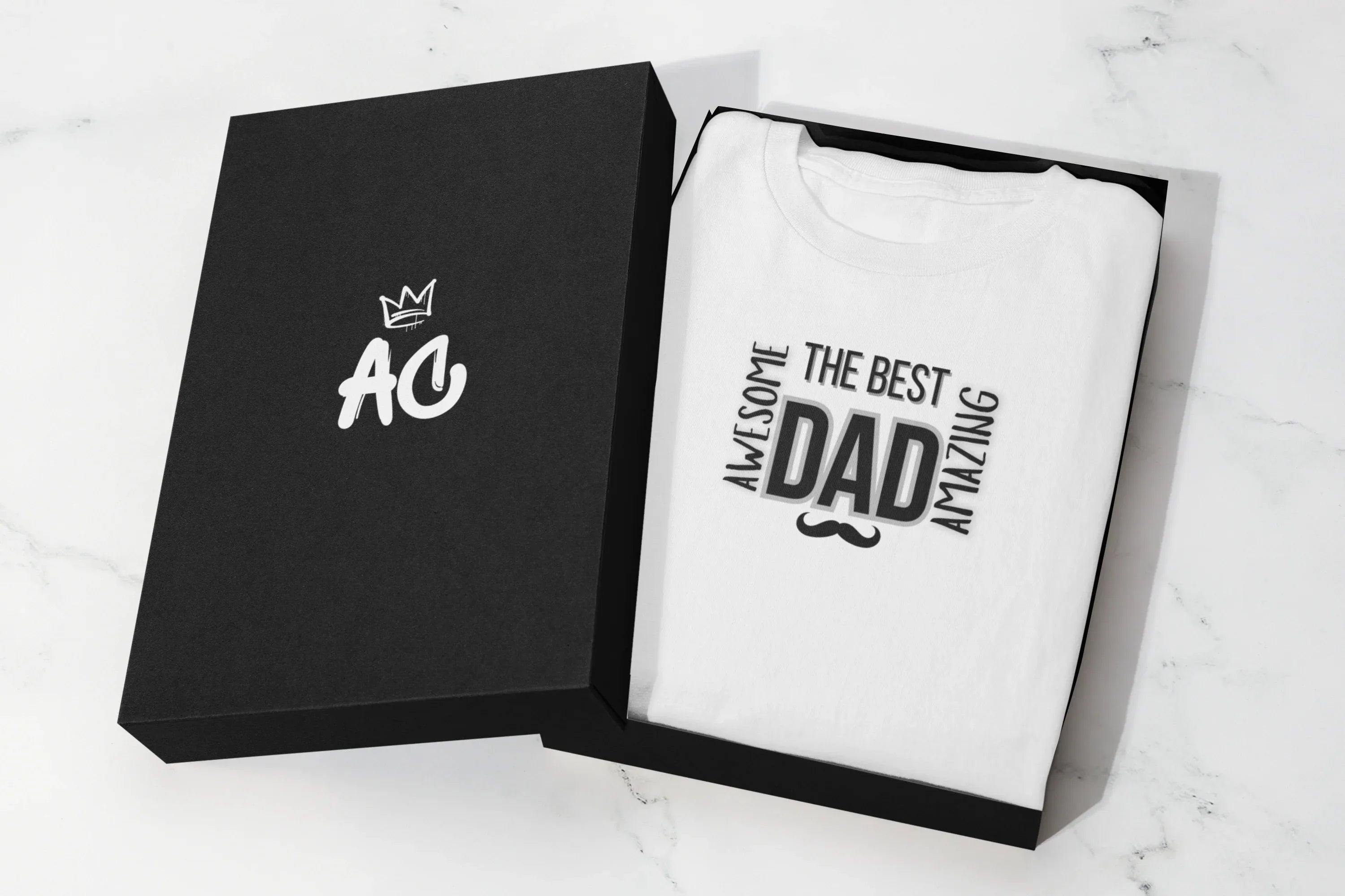 Folded white heavy cotton T-shirt in a black gift box, featuring “The Best Dad” graphic.