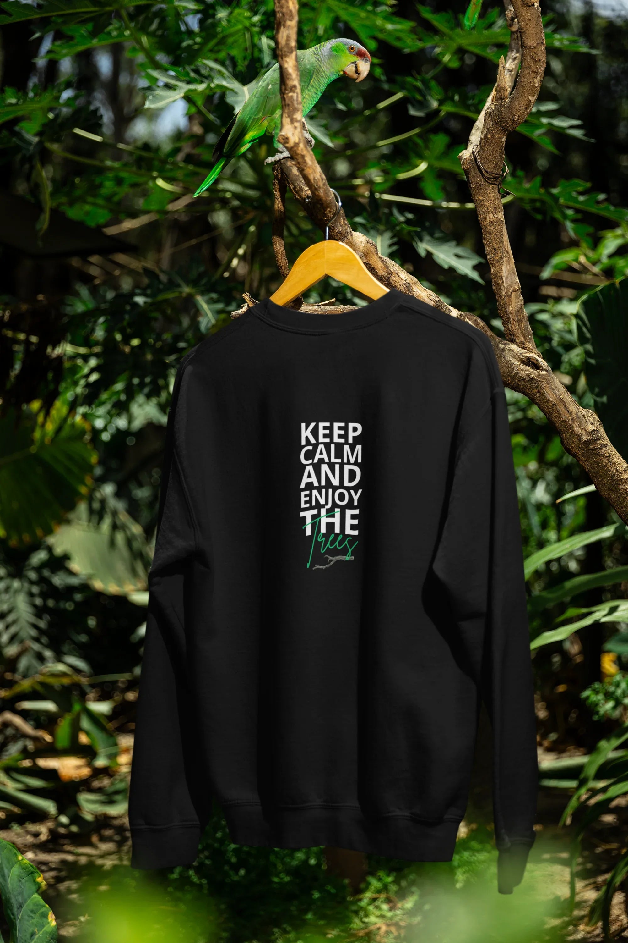 Black sweatshirt on hanger outdoors, front graphic KEEP CALM AND ENJOY THE waves