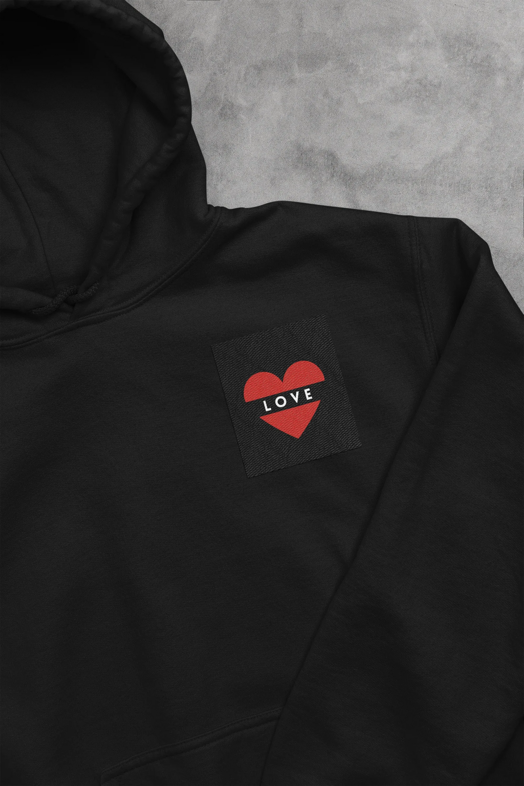 Black unisex hoodie with heart embroidery patch reading LOVE