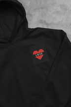 Black unisex hoodie with heart embroidery patch reading LOVE