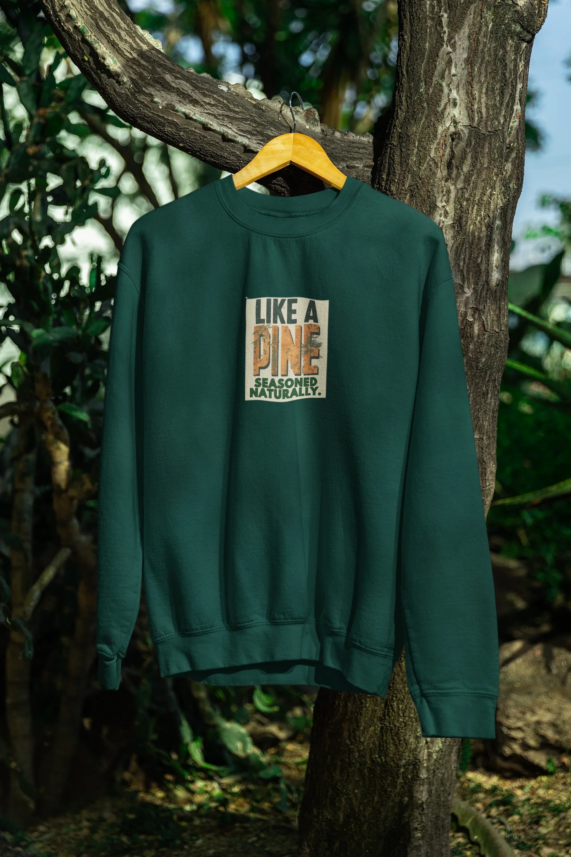 Forest green sweatshirt with crew neck and “Like a Pine” logo print