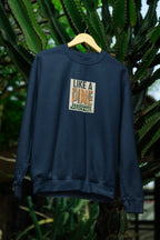Dark blue sweatshirt with crew neck and “Like a Pine” logo print on the chest