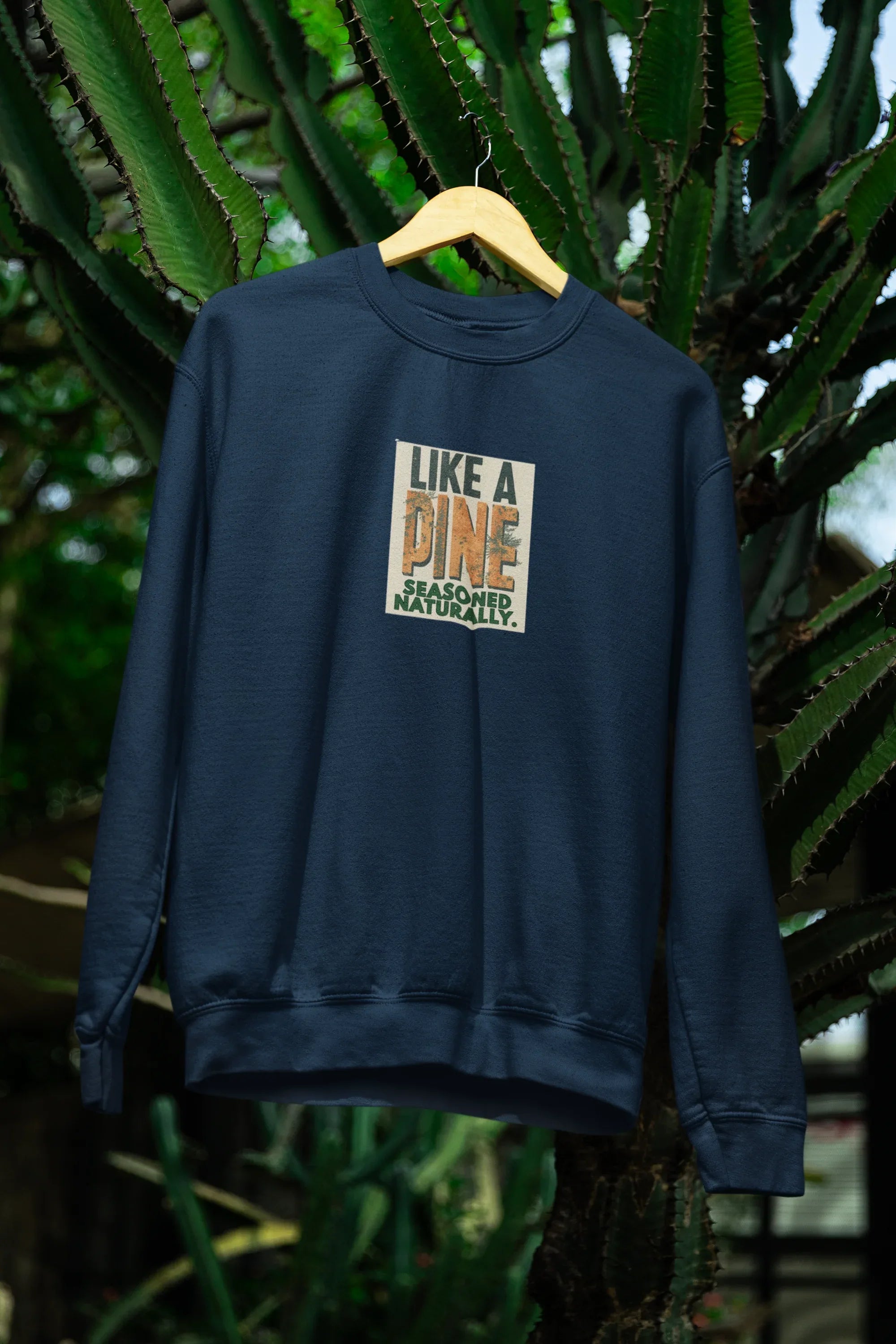 Dark blue sweatshirt with crew neck and “Like a Pine” logo print on the chest
