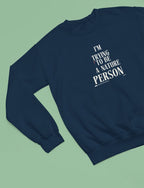 Navy sweatshirt with 'I'm Trying to Be a Nature Person' slogan on front
