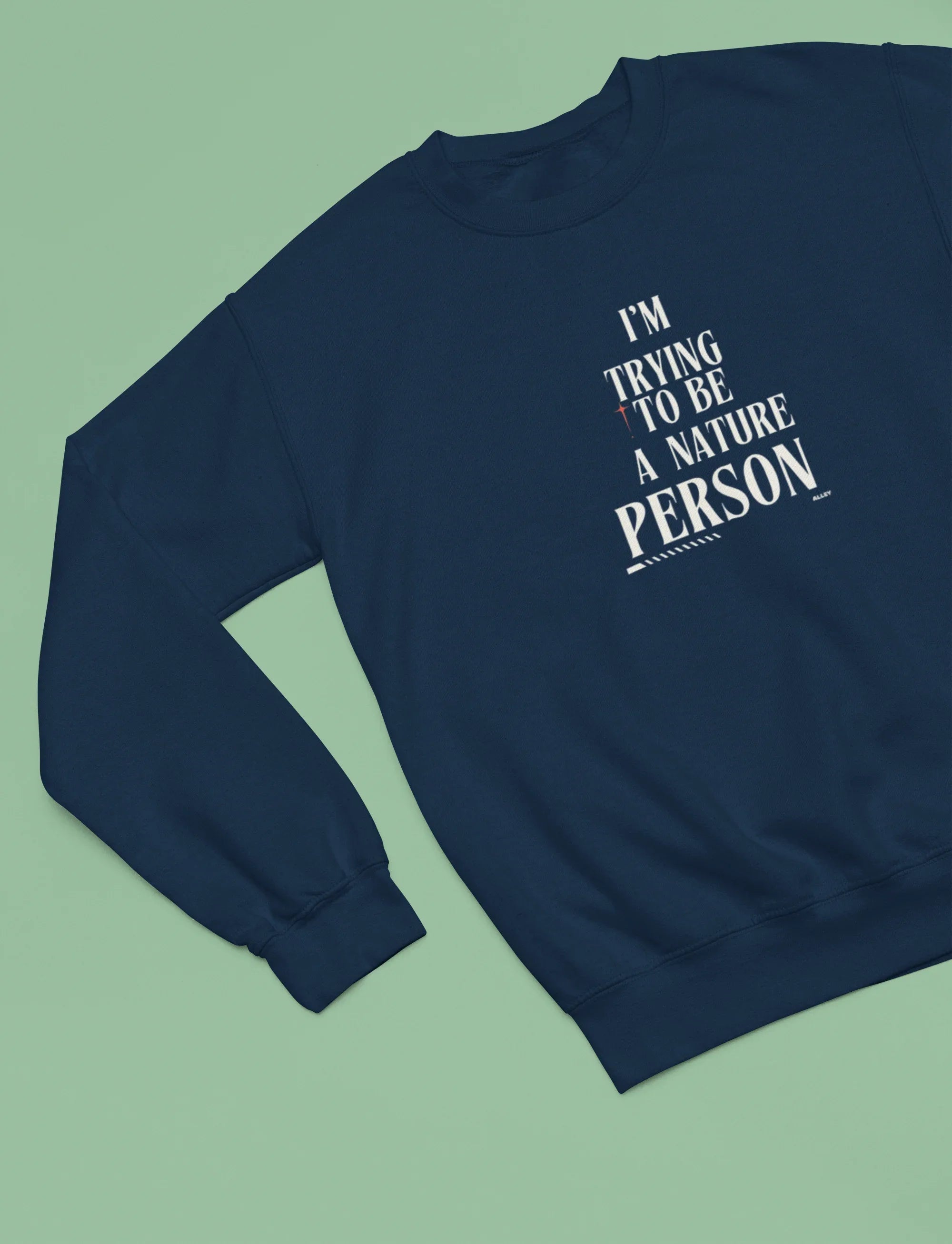 Navy sweatshirt with 'I'm Trying to Be a Nature Person' slogan on front