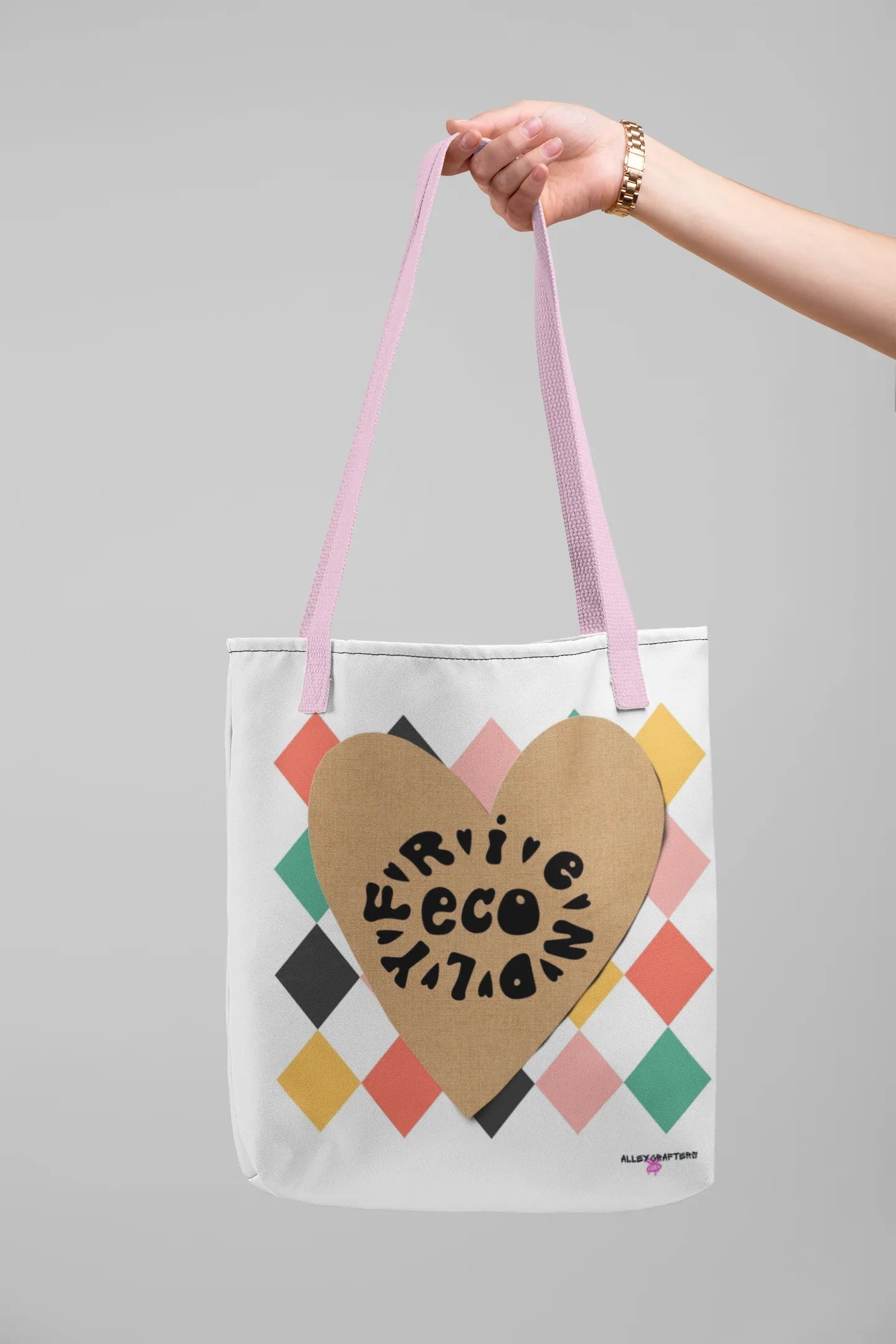 Heart-print tote bag in white canvas with tan heart graphic, multicolor diamonds, pink handles