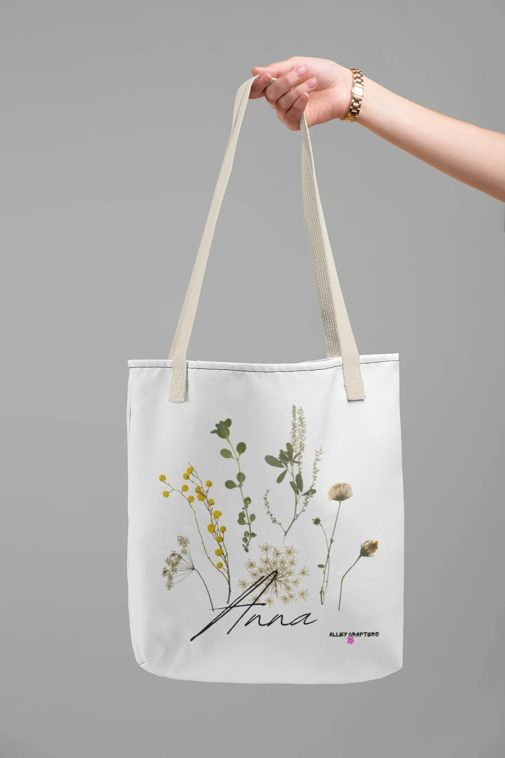 White canvas tote bag with light handle straps and botanical flower print front
