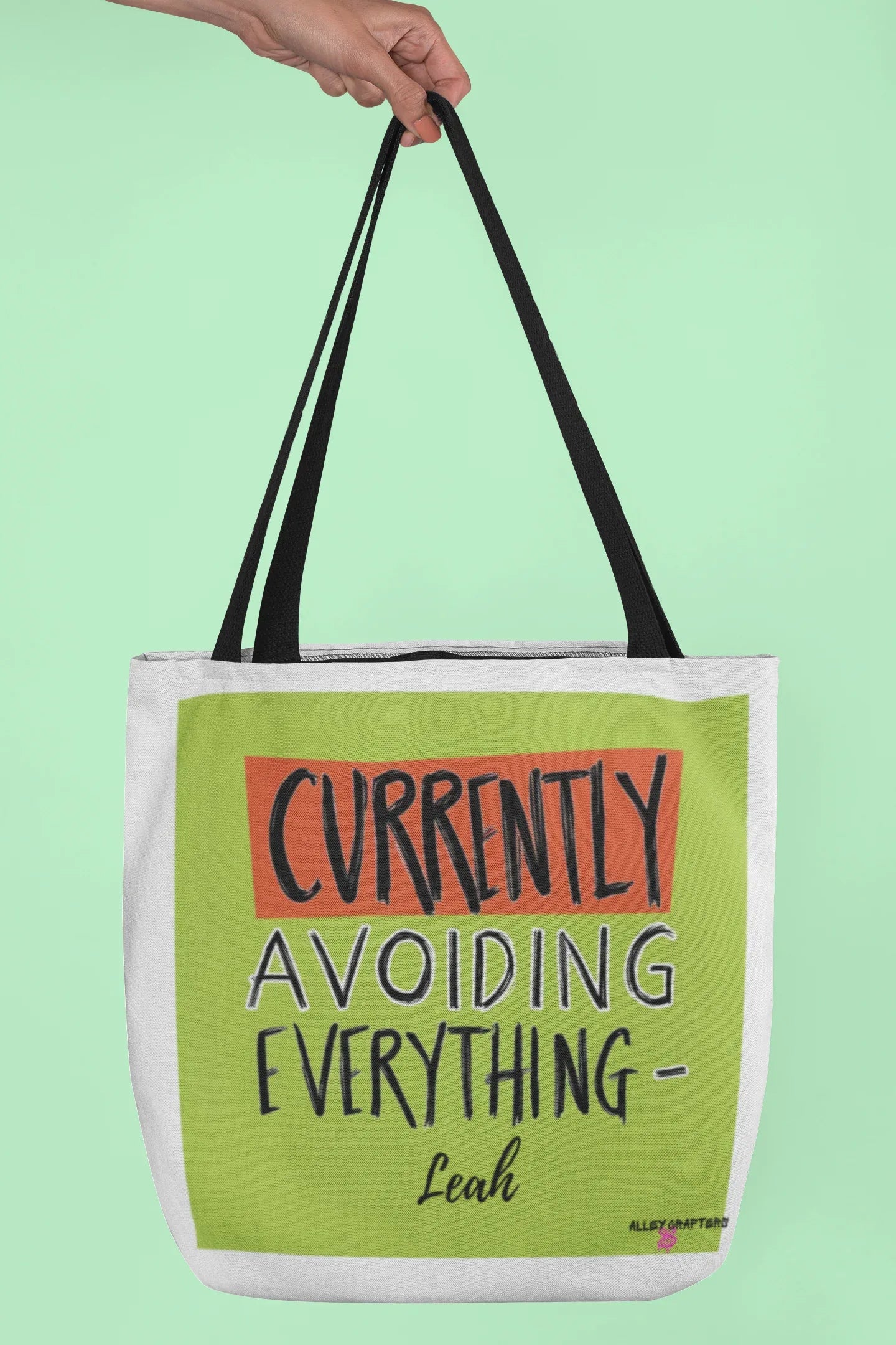 White canvas tote with lime green front panel and 'Currently Avoiding Everything-' text, Leah