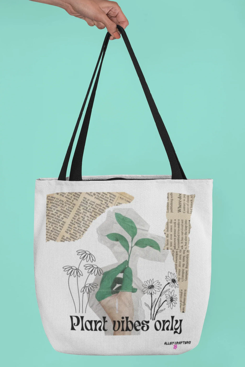 Black-handled white tote bag with green plant graphic and 'Plant vibes only' text