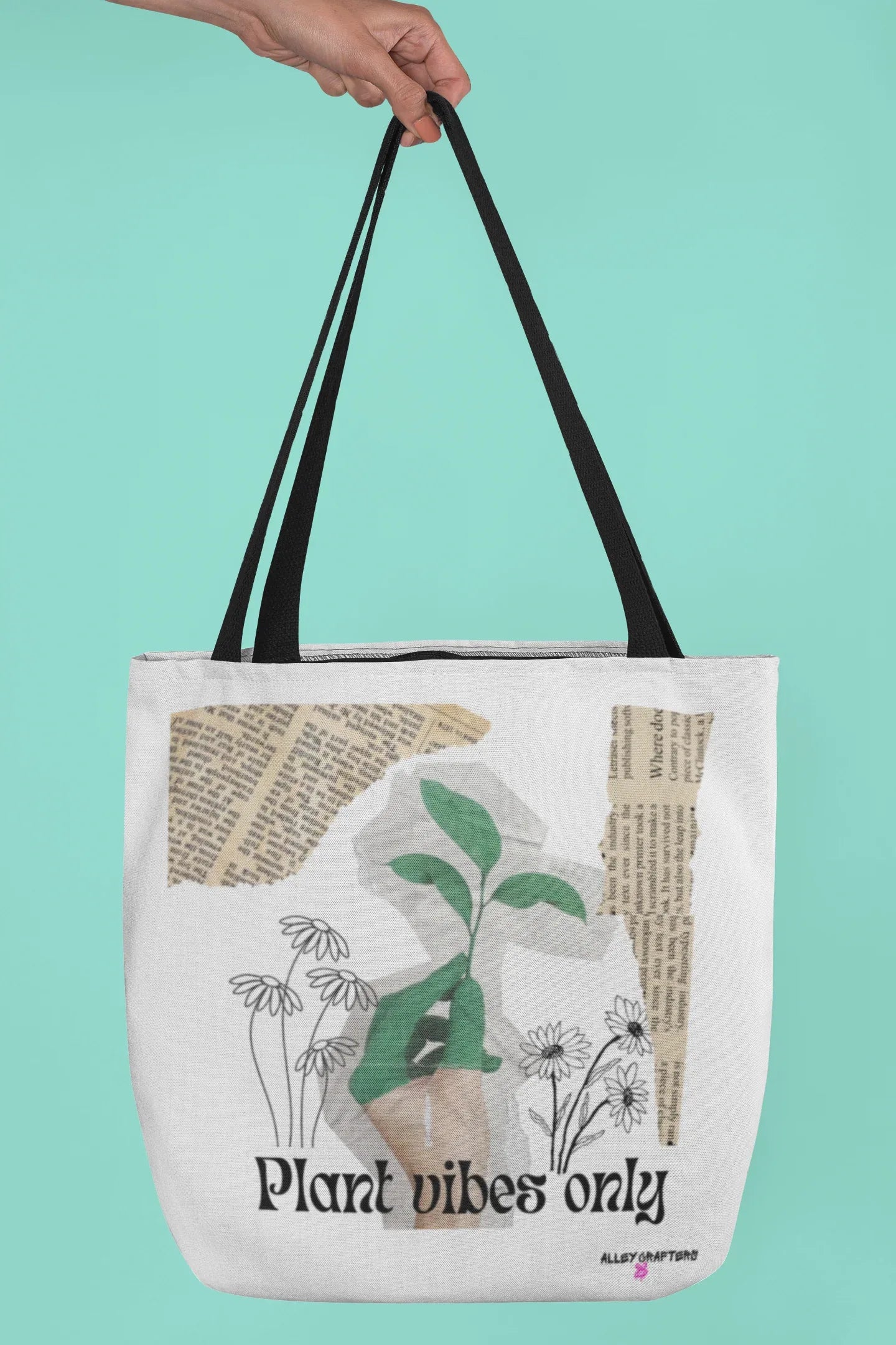 Black-handled white tote bag with green plant graphic and 'Plant vibes only' text
