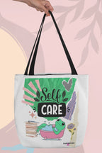 White tote bag with green 'Self Care' frog graphic, striped palm background art