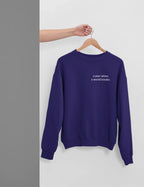 Purple crewneck sweatshirt with 'a year wiser, a world kinder.' print