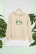 Sand beige hoodie with cactus graphic and “don’t touch me.” text on the chest