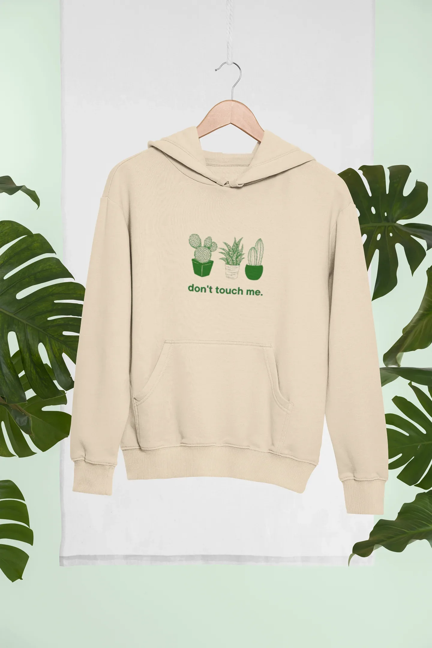 Sand beige hoodie with cactus graphic and “don’t touch me.” text on the chest